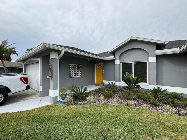 single story home with a garage, roof with shingles, a front yard, and stucco siding