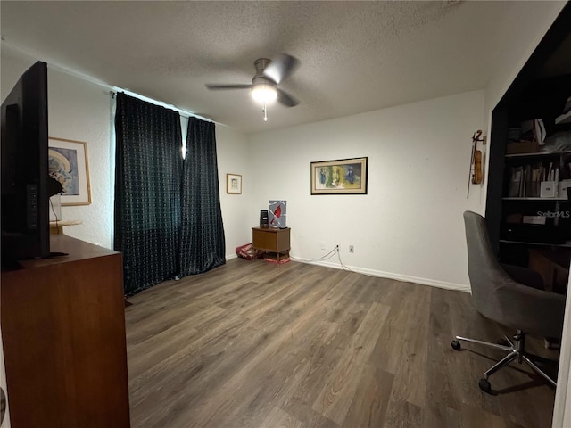 office with ceiling fan, a textured ceiling, and wood finished floors