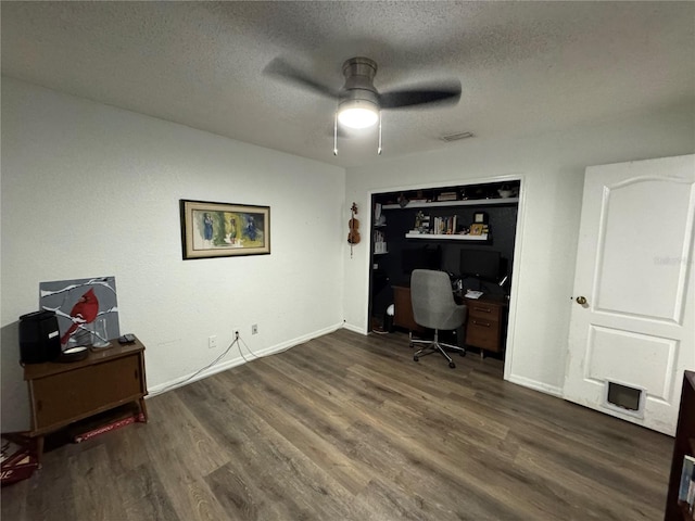 home office featuring baseboards, a textured ceiling, a ceiling fan, and wood finished floors