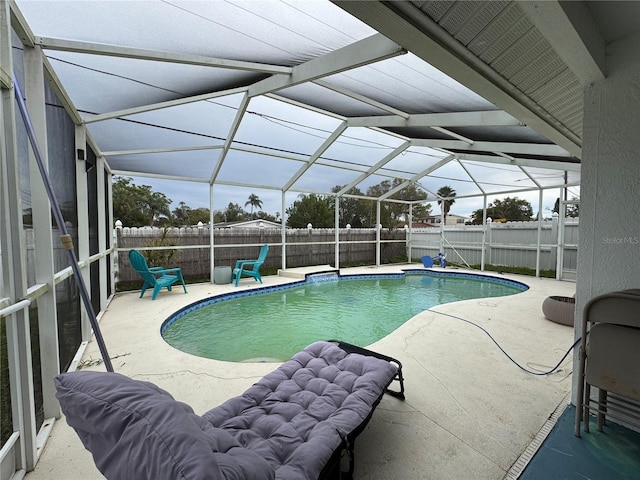 view of pool featuring a lanai, a fenced in pool, a patio, and a fenced backyard