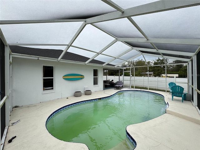 view of swimming pool featuring a patio area, a fenced in pool, a lanai, and fence