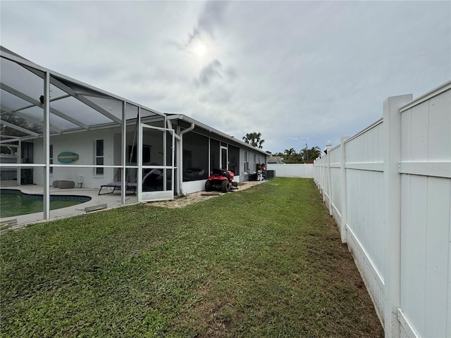 view of yard featuring a lanai, a fenced in pool, a fenced backyard, and a patio area