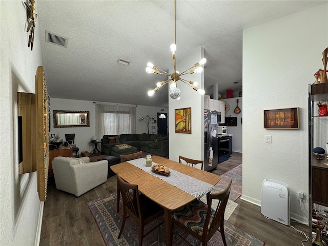 dining space featuring visible vents, dark wood finished floors, a chandelier, lofted ceiling, and a textured ceiling