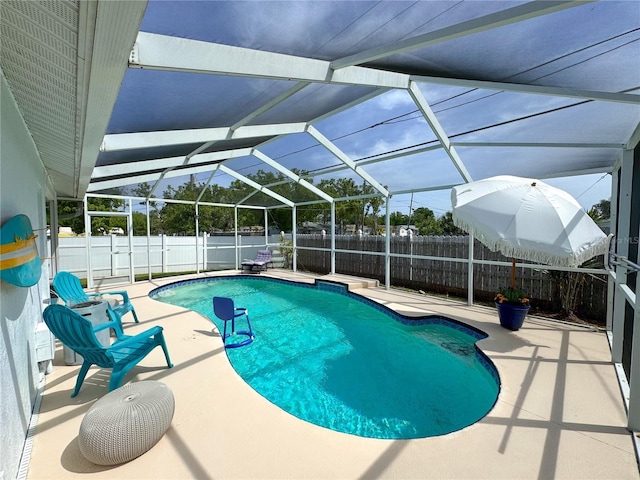 view of swimming pool with a fenced backyard, a patio area, a fenced in pool, and glass enclosure