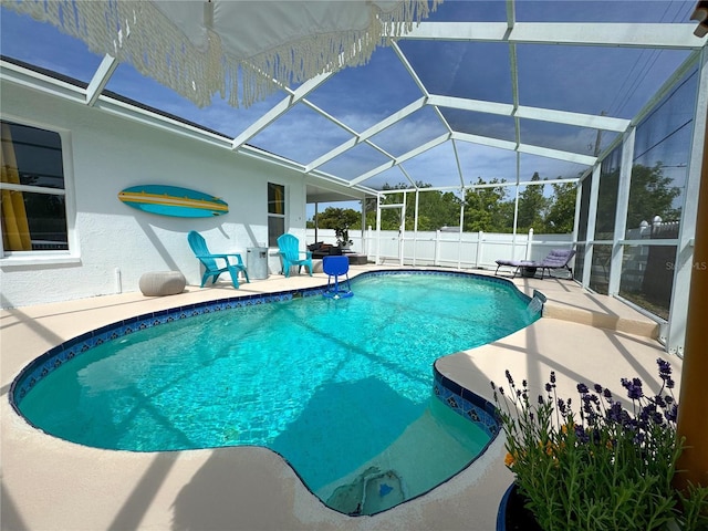 view of pool with a patio area, a fenced in pool, a fenced backyard, and a lanai