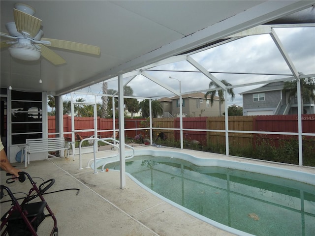 7308 Mako Dr, Hudson, FL 34667 - view of swimming pool featuring a lanai, a patio area, a fenced backyard, and a ceiling fan