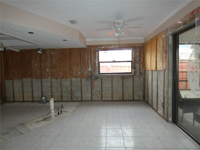 7308 Mako Dr, Hudson, FL 34667 - unfurnished room featuring visible vents, ceiling fan, a textured ceiling, crown molding, and wood walls