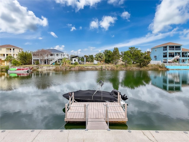 view of dock featuring a water view and a residential view