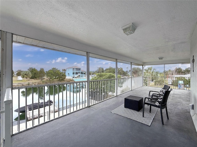 sunroom / solarium featuring a water view