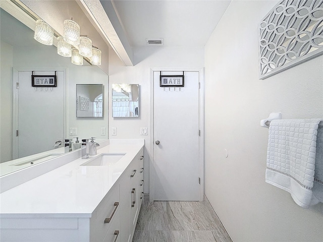 bathroom featuring vanity and visible vents