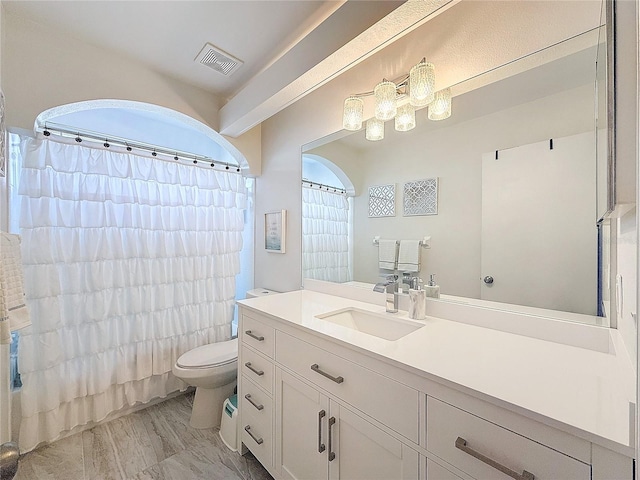 bathroom featuring shower / bath combo, visible vents, vanity, and toilet