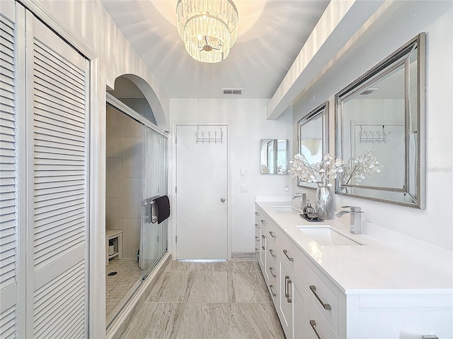 full bath featuring double vanity, a closet, a sink, and visible vents