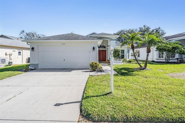 view of front of house featuring driveway, stucco siding, a garage, and a front yard