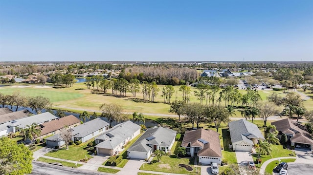 bird's eye view with golf course view, a water view, and a residential view