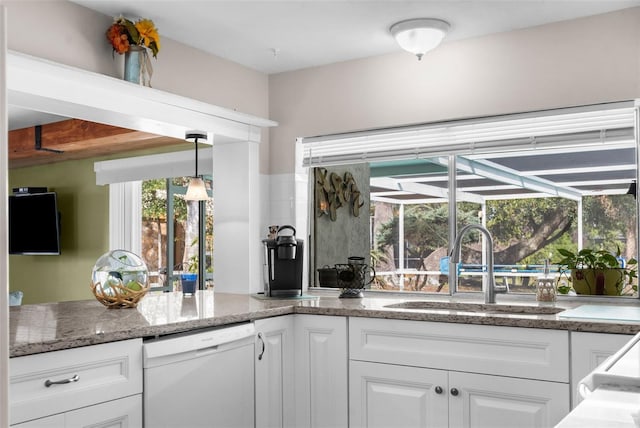 kitchen featuring white cabinets, a sunroom, hanging light fixtures, white dishwasher, and a sink