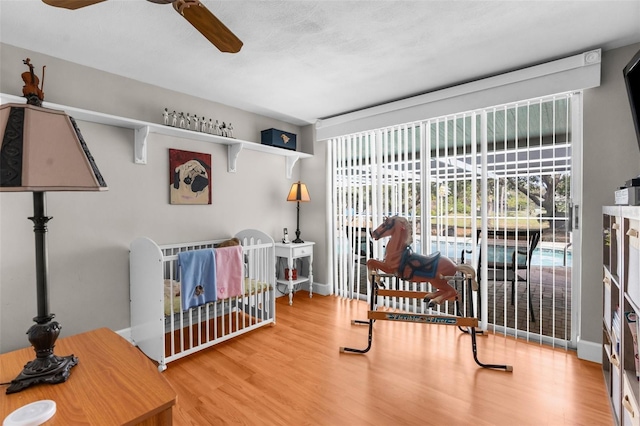 bedroom with baseboards and wood finished floors