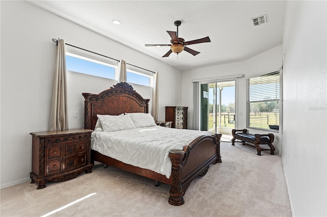 carpeted bedroom with ceiling fan, visible vents, baseboards, and access to exterior