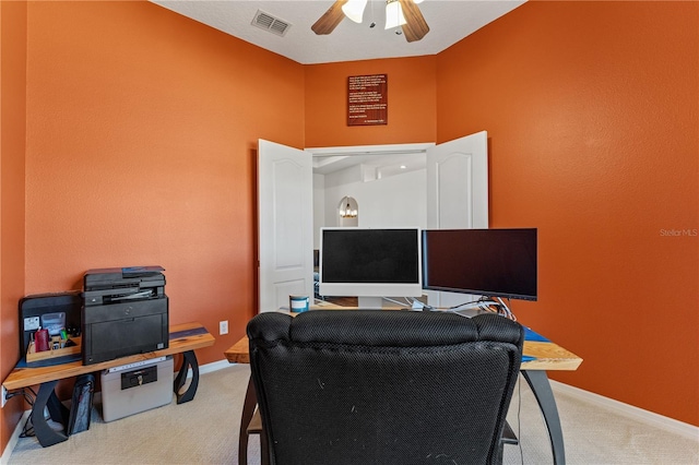 carpeted office with visible vents, baseboards, and ceiling fan