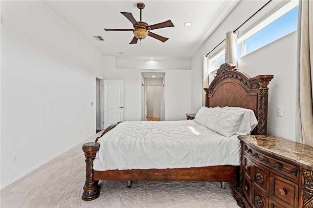 carpeted bedroom with visible vents, baseboards, and a ceiling fan