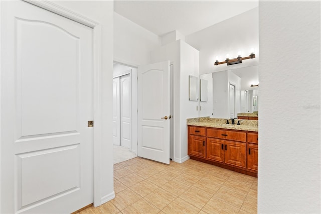 bathroom featuring baseboards and vanity