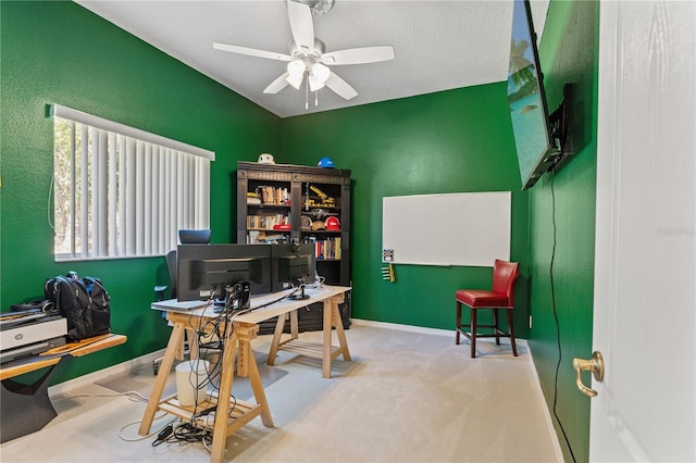 carpeted office featuring baseboards and ceiling fan