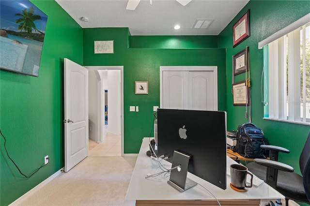 office space featuring light carpet, visible vents, and baseboards