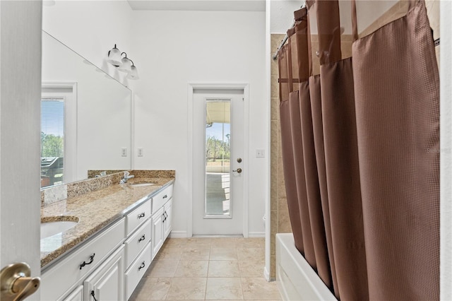 full bathroom featuring a sink, shower / bath combination with curtain, double vanity, and tile patterned flooring