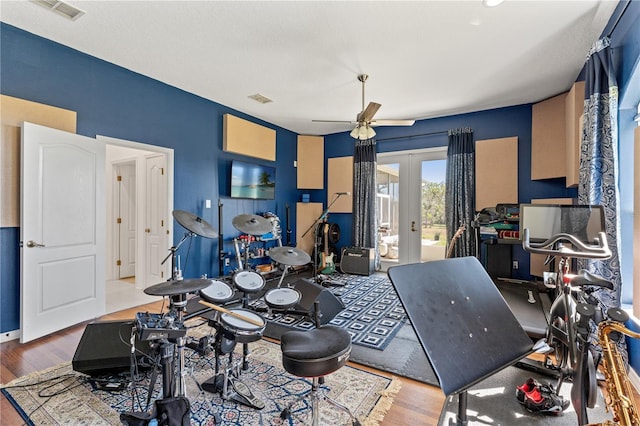 rec room with ceiling fan, french doors, visible vents, and wood finished floors