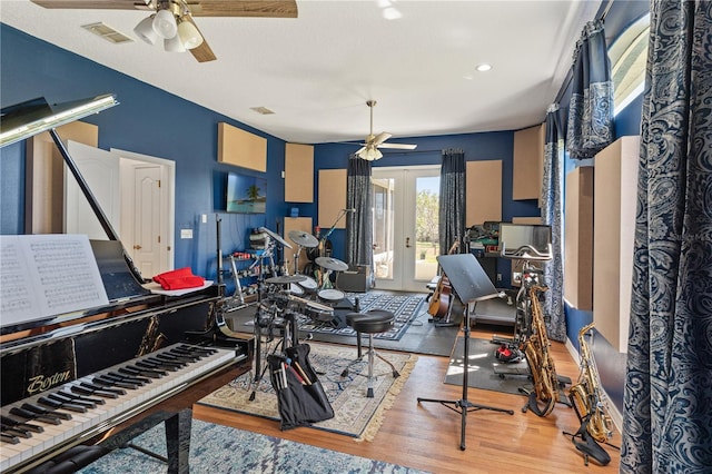 interior space with wood finished floors, french doors, visible vents, and ceiling fan