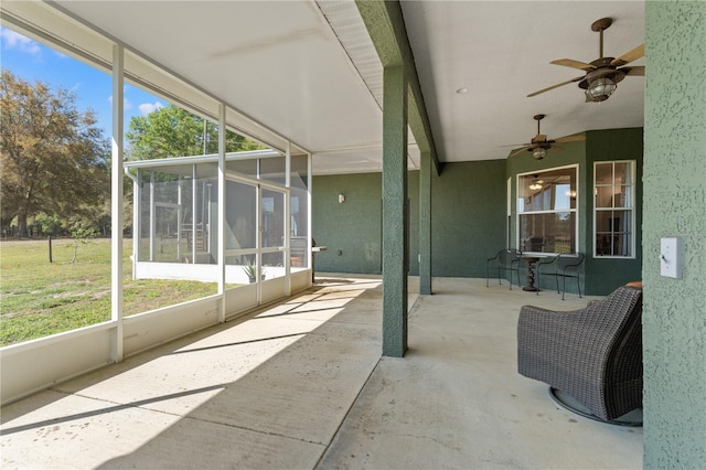 sunroom / solarium featuring plenty of natural light and ceiling fan