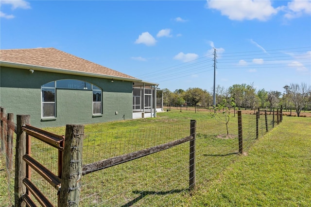 view of yard with fence and a sunroom