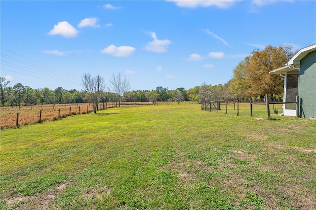 view of yard featuring a rural view and fence