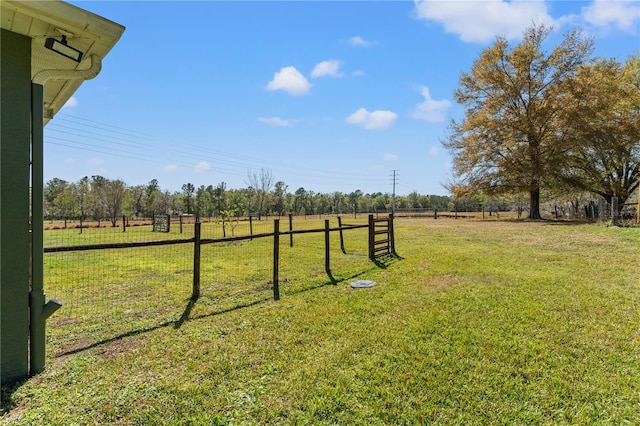 view of yard featuring a rural view and fence