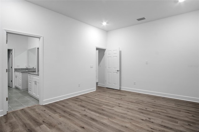 spare room featuring recessed lighting, visible vents, light wood-style flooring, and baseboards