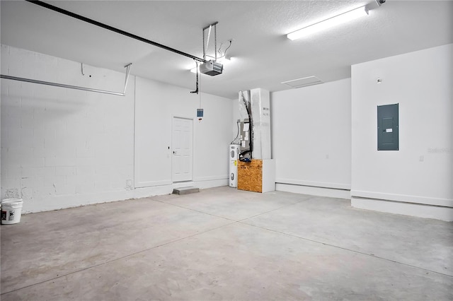 garage with concrete block wall, electric panel, and a garage door opener