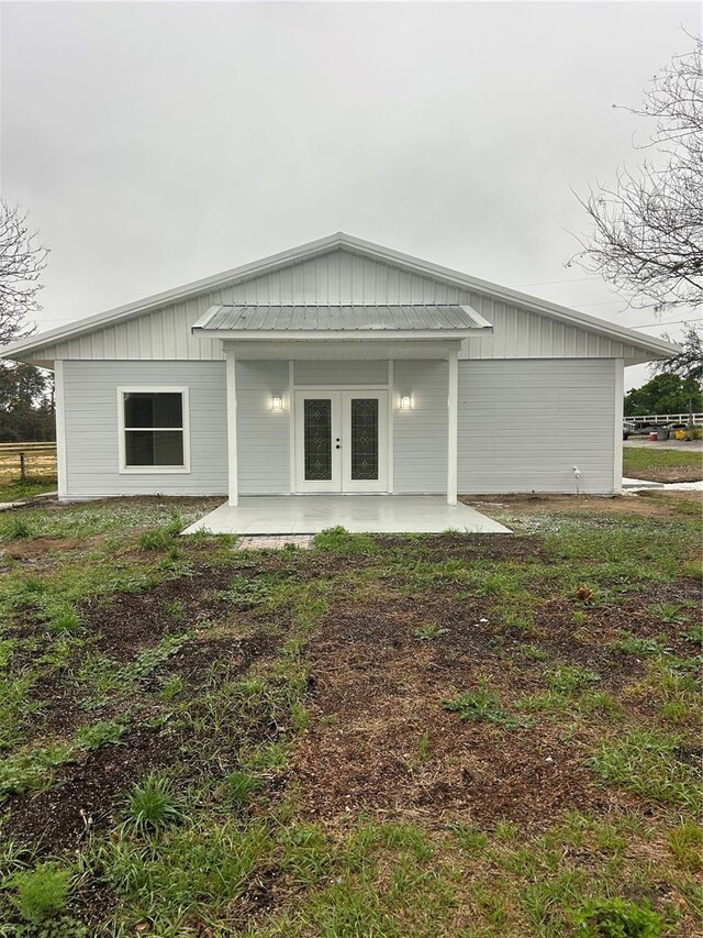 rear view of property featuring french doors
