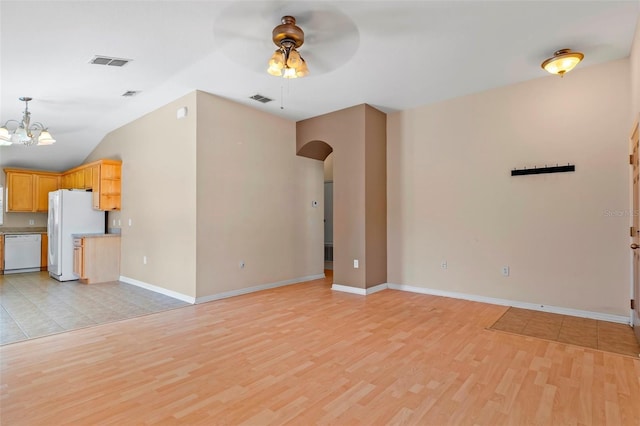 unfurnished living room with light wood finished floors, visible vents, arched walkways, and ceiling fan with notable chandelier