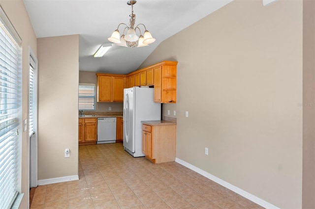 kitchen featuring light countertops, an inviting chandelier, a sink, white appliances, and baseboards