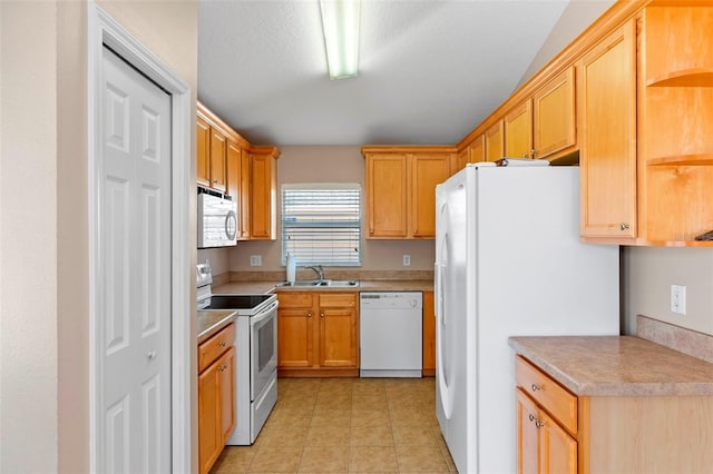 kitchen featuring light tile patterned floors, open shelves, light countertops, a sink, and white appliances