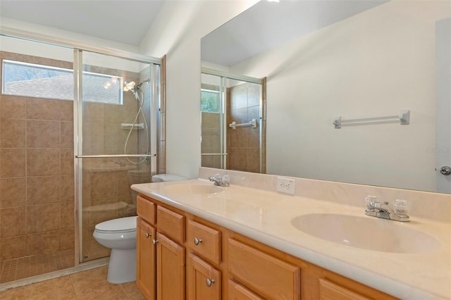 bathroom featuring a sink, a shower stall, and tile patterned floors