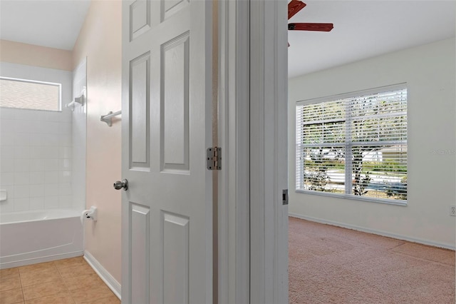 full bath featuring tile patterned flooring, baseboards, and tub / shower combination