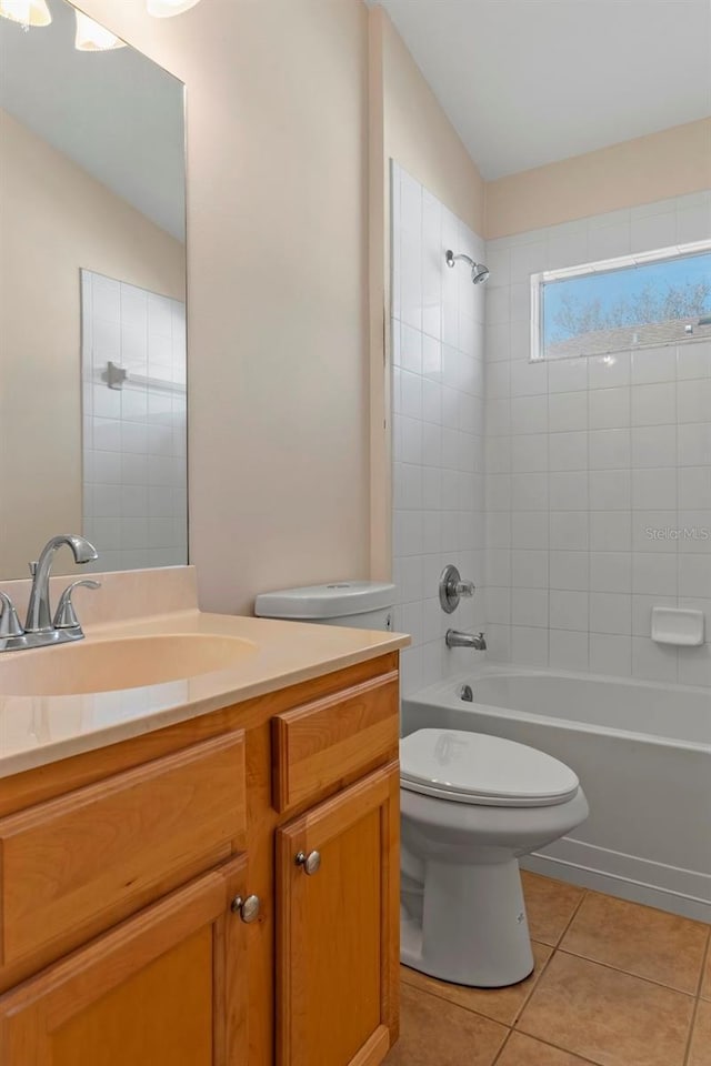 bathroom with vanity, shower / bath combination, tile patterned flooring, and toilet