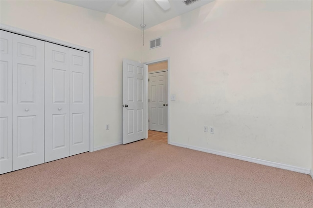 unfurnished bedroom with baseboards, a closet, visible vents, and carpet flooring