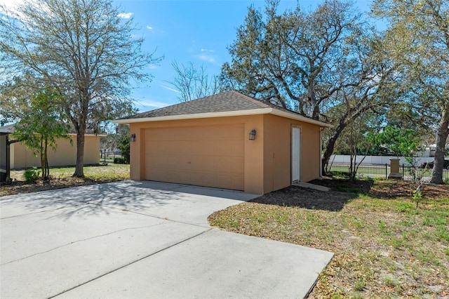 detached garage featuring fence