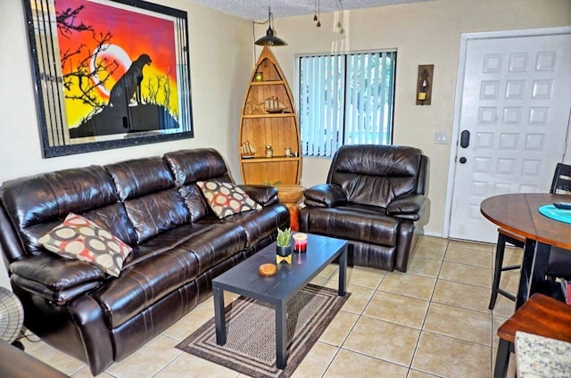 living room featuring a textured ceiling and light tile patterned flooring