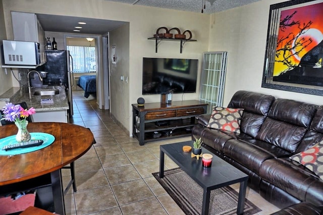 living room featuring a textured ceiling and tile patterned floors