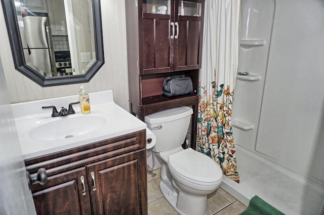 full bathroom with a stall shower, tile patterned flooring, vanity, and toilet