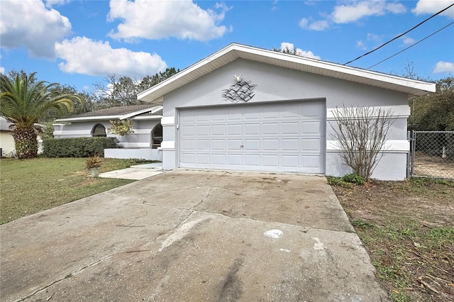 ranch-style house featuring a garage, concrete driveway, a front yard, and stucco siding