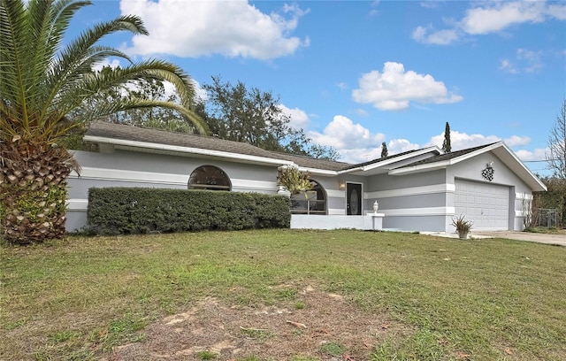 single story home featuring a front yard, driveway, an attached garage, and stucco siding