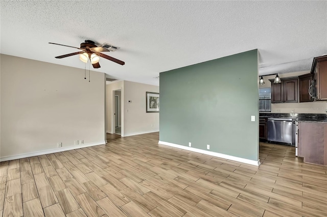 unfurnished living room with baseboards, visible vents, a ceiling fan, light wood-style flooring, and a textured ceiling